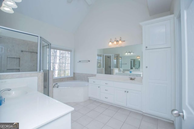 full bathroom featuring a garden tub, a sink, two vanities, a shower stall, and tile patterned floors