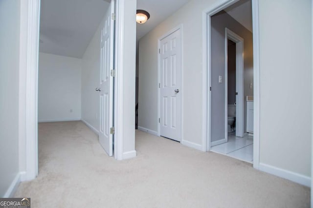 interior space featuring baseboards and carpet flooring