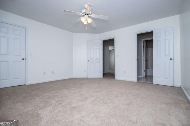 unfurnished bedroom with ceiling fan, carpet floors, and baseboards