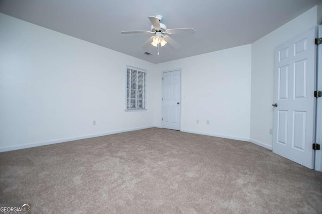 unfurnished bedroom featuring a ceiling fan, carpet, visible vents, and baseboards