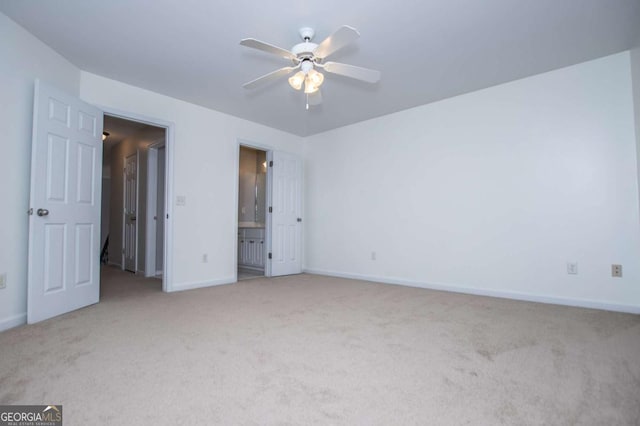 unfurnished bedroom with carpet, ceiling fan, baseboards, and ensuite bathroom