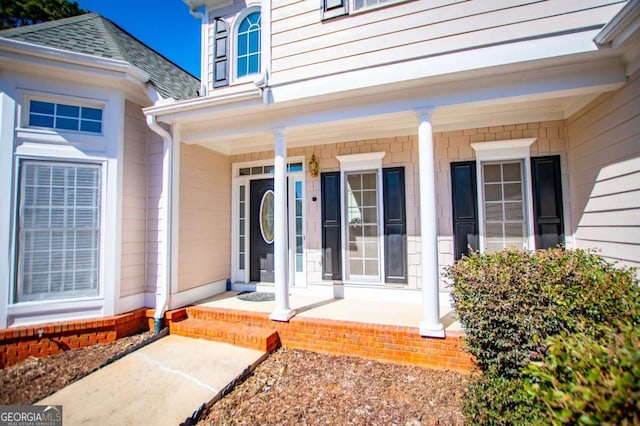 view of exterior entry with a porch