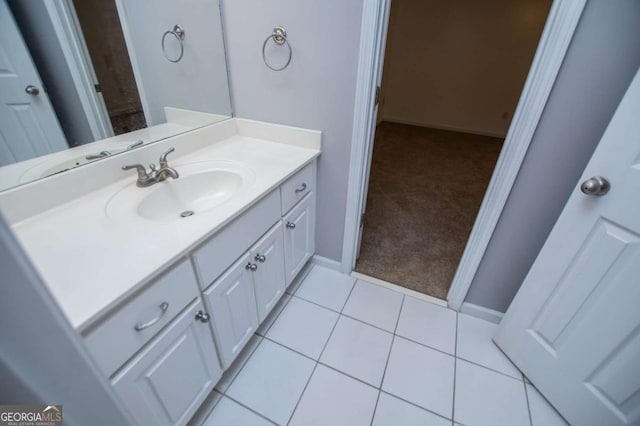 bathroom with tile patterned flooring, vanity, and baseboards