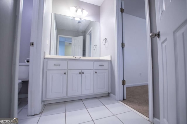 bathroom featuring toilet, tile patterned flooring, and vanity