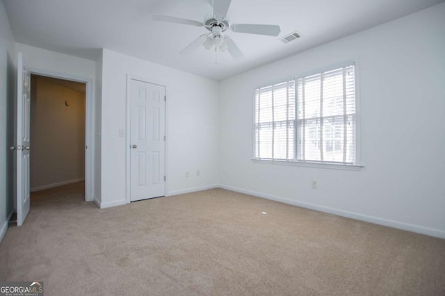 unfurnished bedroom with carpet floors, visible vents, and baseboards