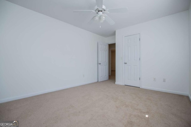 unfurnished bedroom featuring ceiling fan, carpet, and baseboards