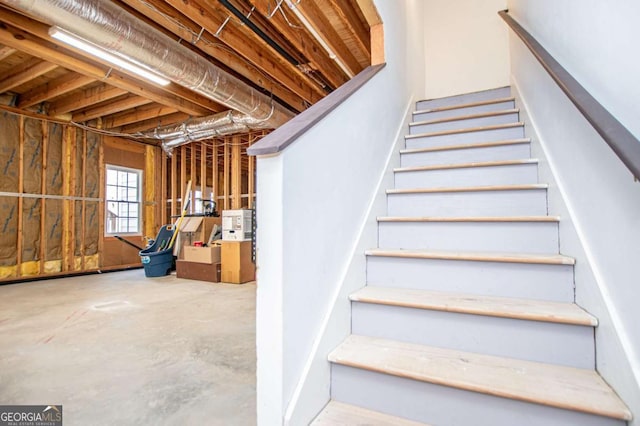 staircase with concrete floors