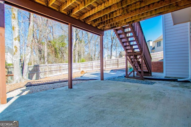 view of patio / terrace featuring a fenced backyard and stairs