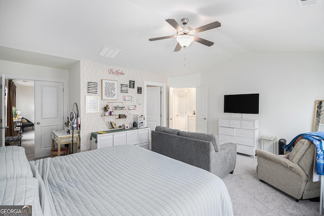 bedroom featuring a ceiling fan, light colored carpet, vaulted ceiling, and wallpapered walls