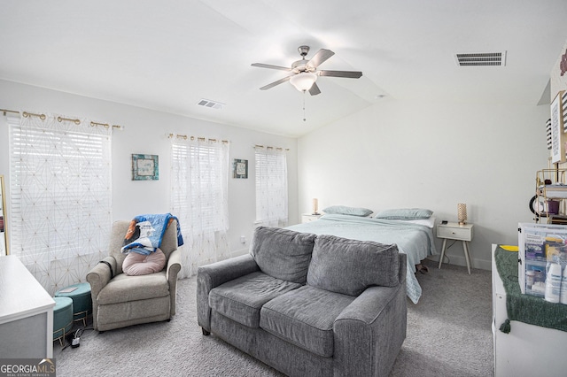 bedroom with carpet, visible vents, vaulted ceiling, and a ceiling fan