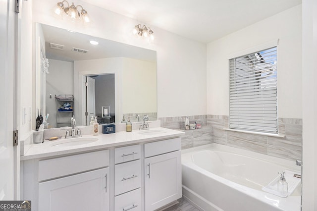 full bath featuring double vanity, a sink, and visible vents