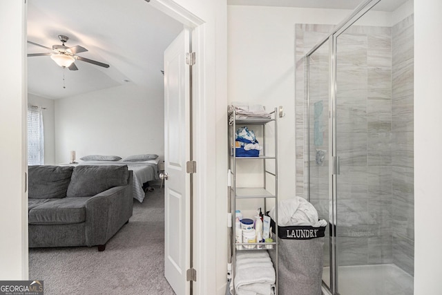 ensuite bathroom with a stall shower, ceiling fan, and ensuite bathroom