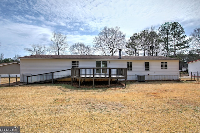 rear view of property featuring a yard, fence, cooling unit, and a wooden deck