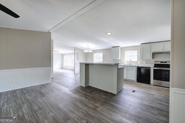 kitchen featuring black dishwasher, wood finished floors, open floor plan, stainless steel range with electric cooktop, and light countertops