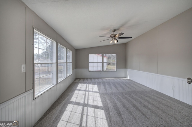 unfurnished sunroom featuring a ceiling fan and lofted ceiling