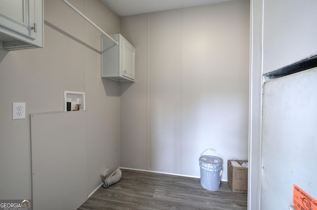 laundry room featuring cabinet space, wood finished floors, and washer hookup