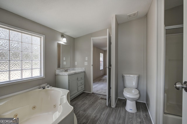 full bath featuring a shower with door, visible vents, a whirlpool tub, wood finished floors, and vanity