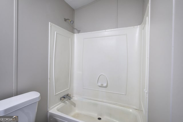 bathroom featuring shower / bath combination and toilet