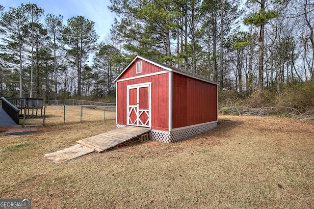 view of shed featuring fence