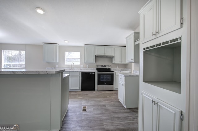 kitchen with visible vents, stainless steel range with electric stovetop, light wood-style flooring, under cabinet range hood, and black dishwasher