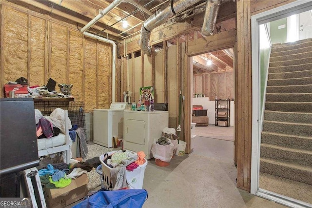 unfinished basement featuring stairway and washer and clothes dryer