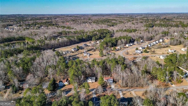 birds eye view of property with a wooded view