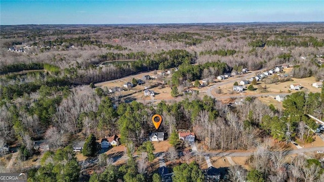 birds eye view of property featuring a wooded view