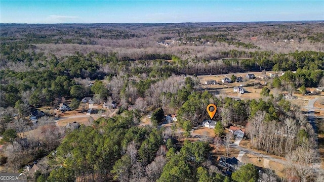 drone / aerial view with a wooded view