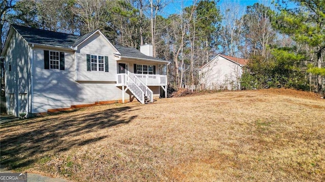 single story home featuring a front lawn, stairway, and a chimney