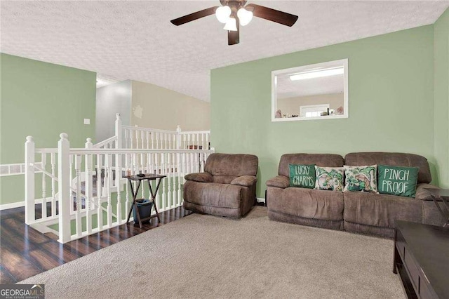 living room featuring a ceiling fan and a textured ceiling