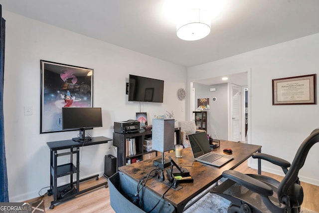 home office with light wood finished floors and baseboards