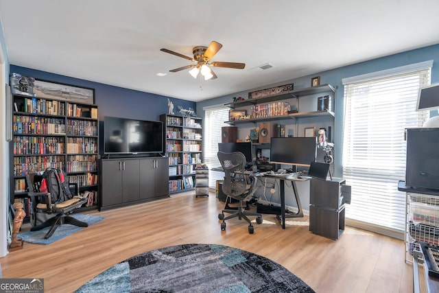 office with visible vents, wood finished floors, and a ceiling fan