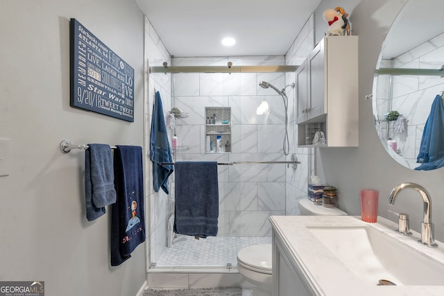 bathroom featuring a stall shower, vanity, and toilet