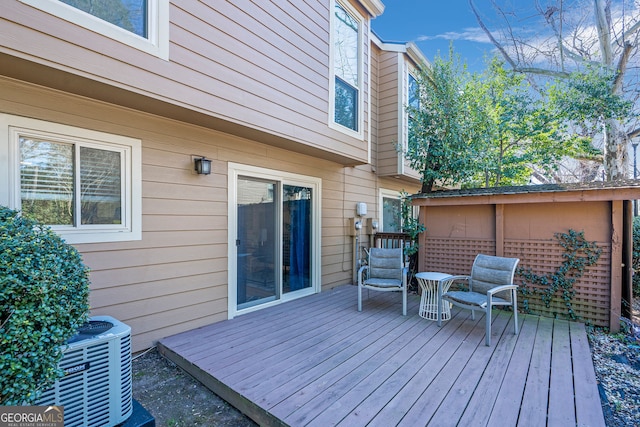 wooden deck featuring central air condition unit