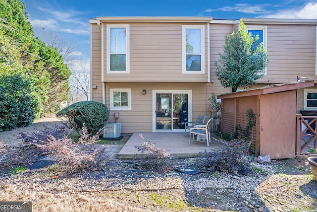 back of house featuring central AC unit and a wooden deck