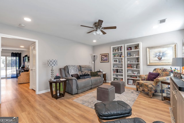 living room with baseboards, visible vents, a ceiling fan, light wood-style flooring, and recessed lighting