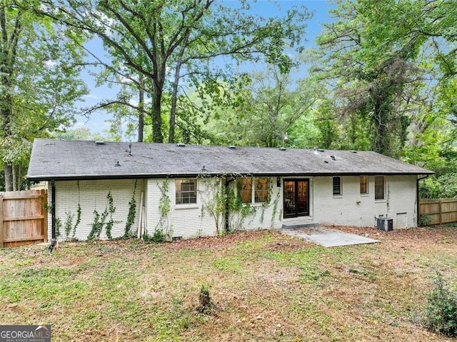 back of house with crawl space, fence, central AC unit, and brick siding