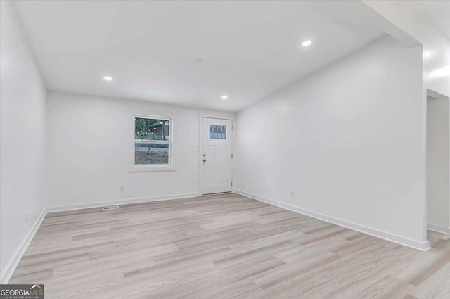 interior space with baseboards and light wood-type flooring