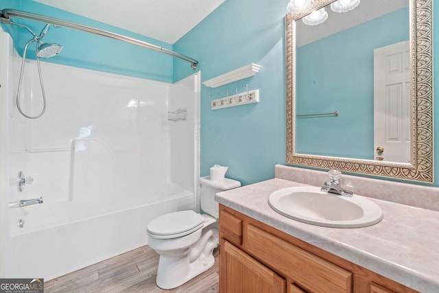 bathroom featuring bathing tub / shower combination, vanity, toilet, and wood finished floors