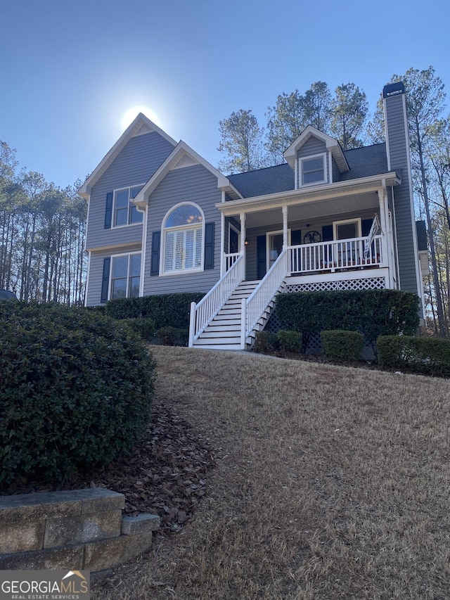 view of front of property with a chimney and a porch