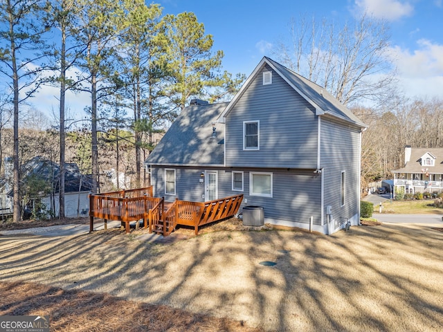 rear view of house with a deck and central AC unit