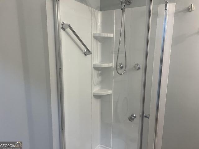 full bath featuring a shower stall