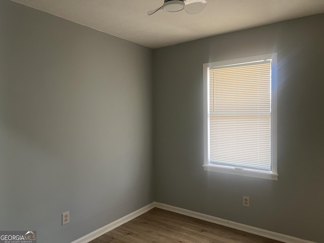 unfurnished room featuring wood finished floors and baseboards