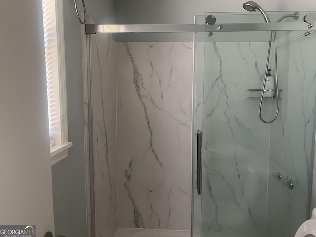 full bathroom featuring a marble finish shower