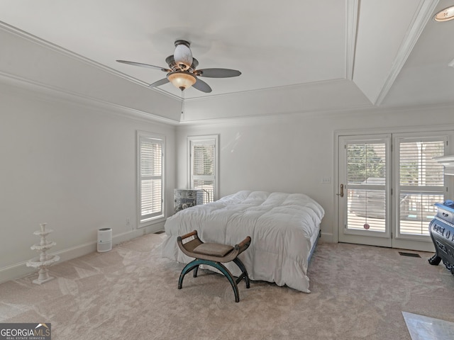 carpeted bedroom featuring access to exterior, multiple windows, and ornamental molding