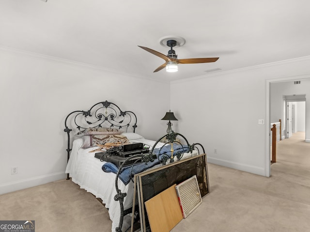 bedroom featuring ceiling fan, baseboards, crown molding, and light colored carpet