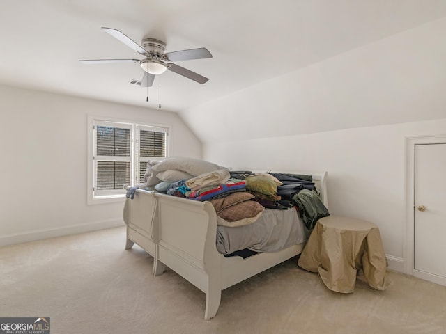 bedroom featuring light carpet, baseboards, and vaulted ceiling