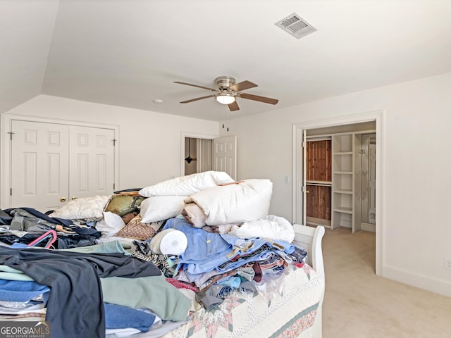 bedroom featuring light colored carpet, a ceiling fan, baseboards, visible vents, and a closet