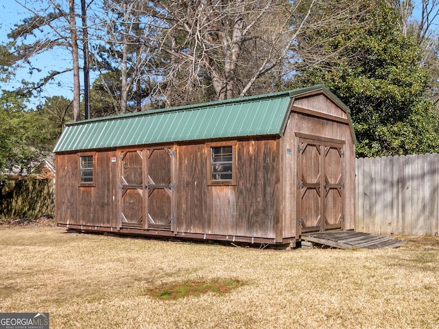 view of shed featuring fence