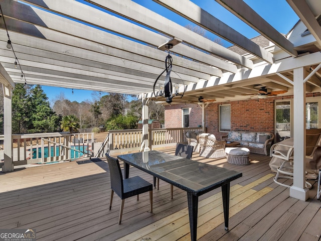 wooden terrace with ceiling fan, an outdoor pool, an outdoor living space, and a pergola